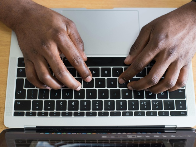hands typing on laptop