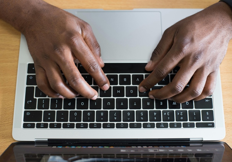 hands typing on laptop